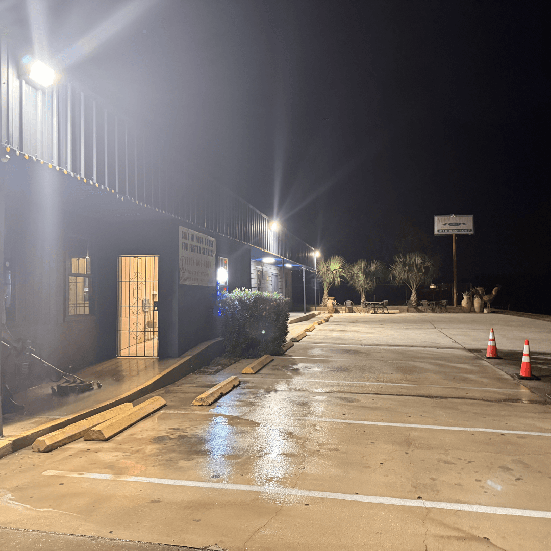 Same commercial parking bay after Torres Pressure Washing — clean concrete