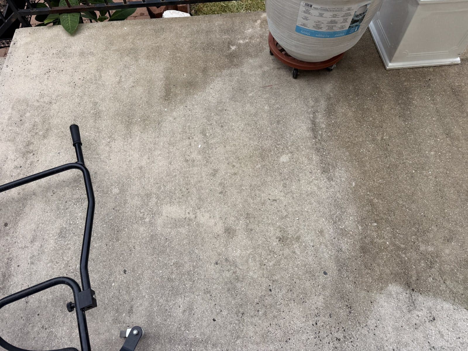 Close-up of the line between cleaned and untouched concrete partway through a residential job