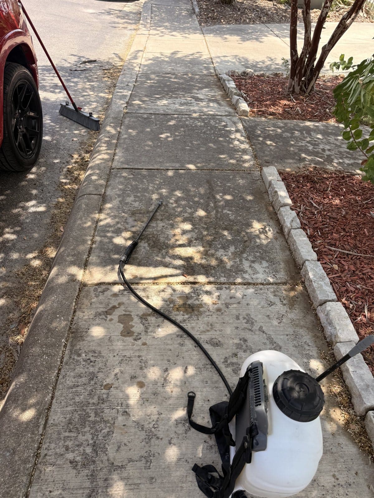 Pressure washing equipment staged on a dirty residential walkway before the job starts